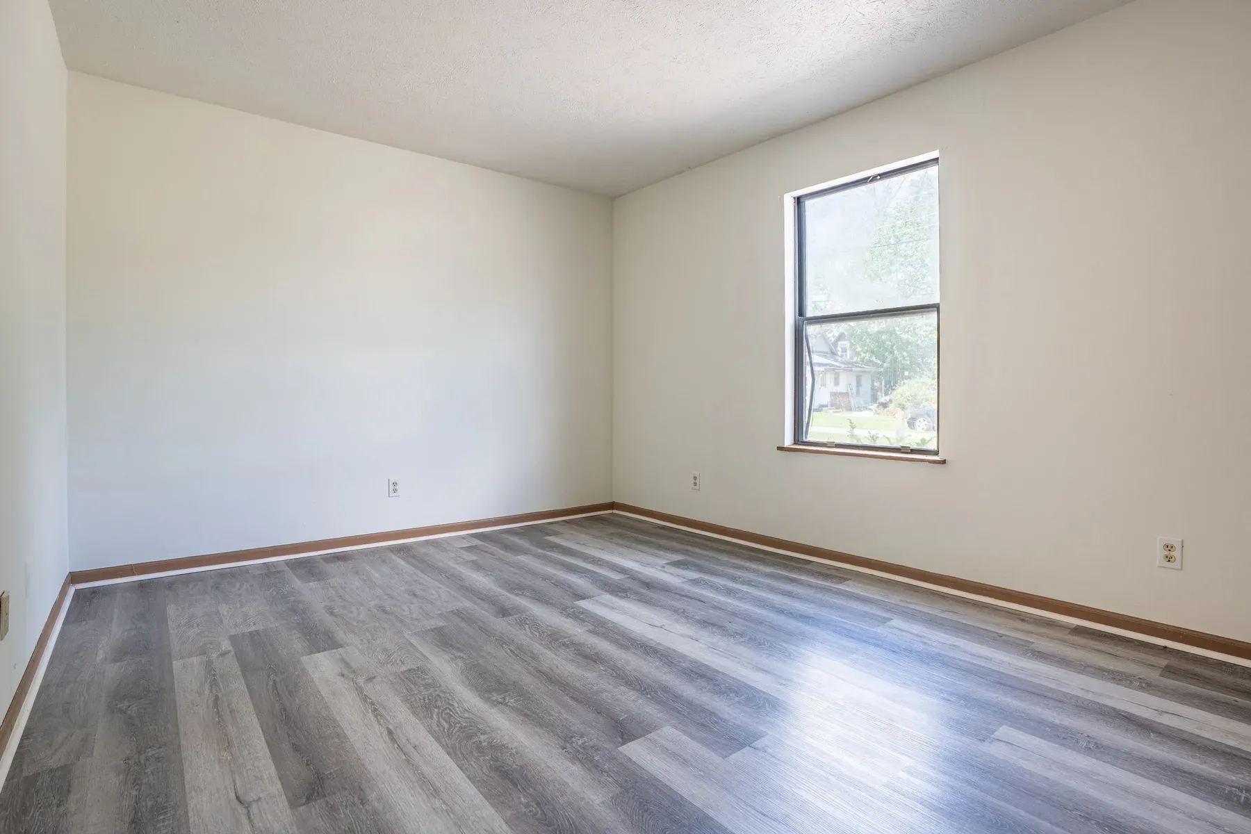 Living room with a large window and neutral paint
