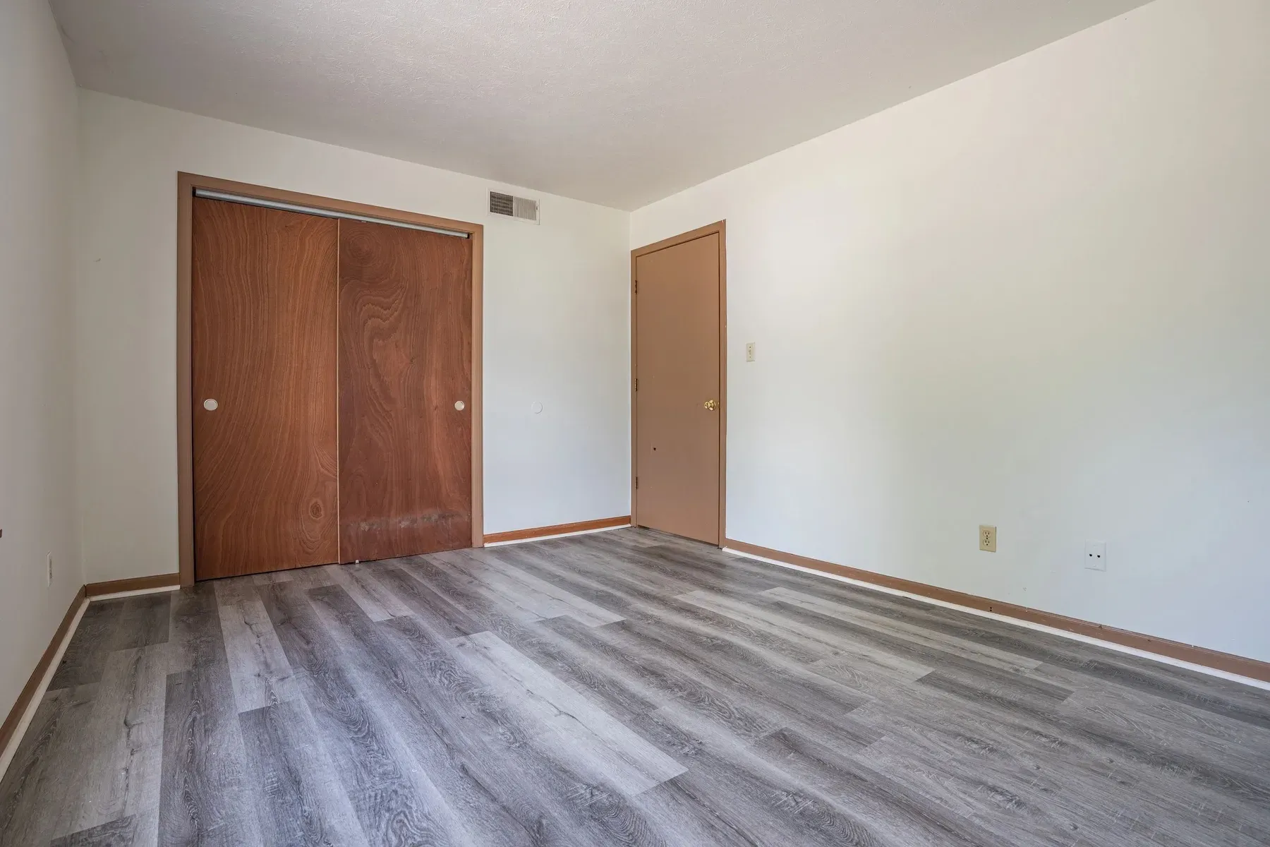 Renovated apartment interior with wide-plank flooring