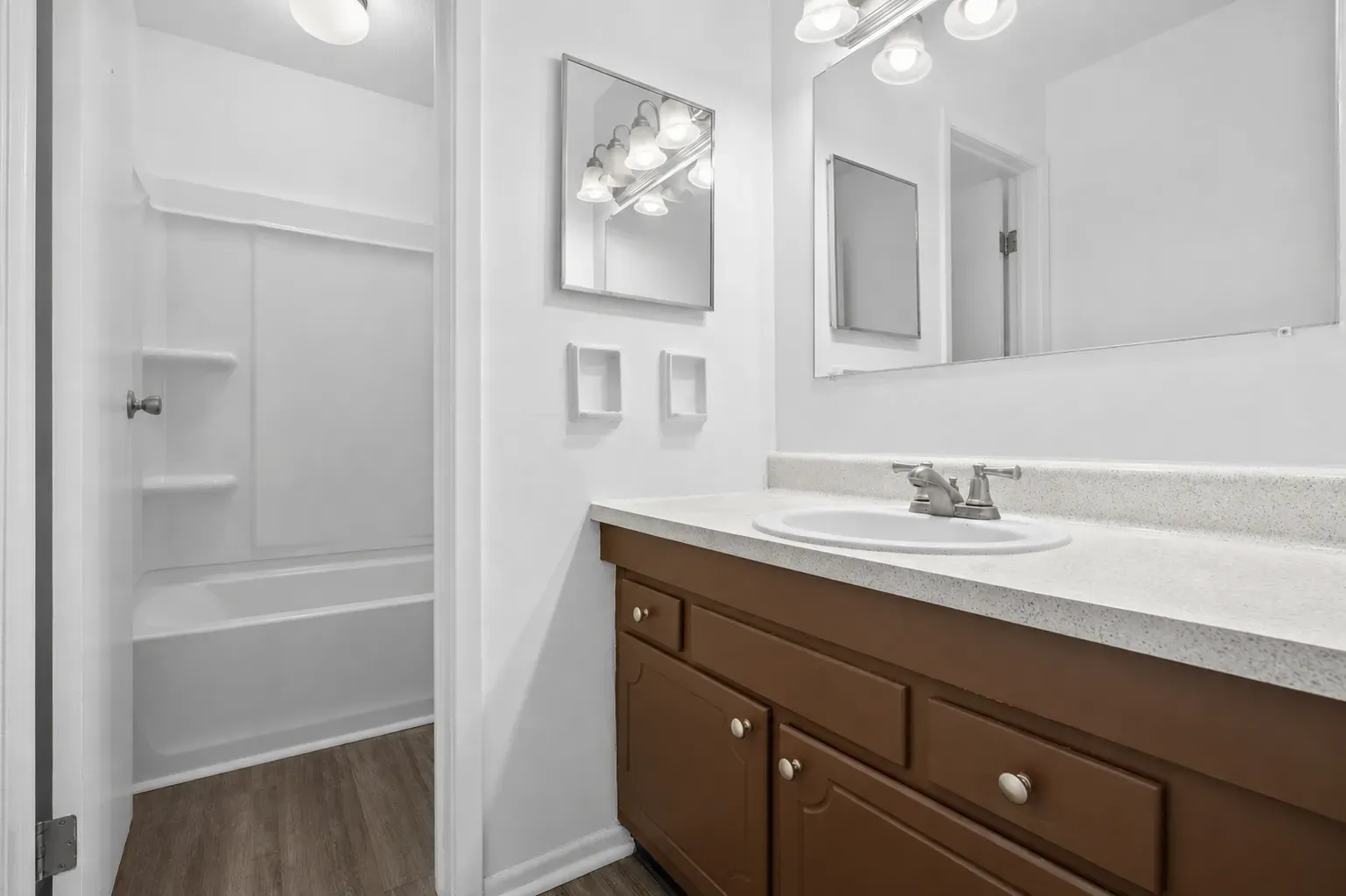 Bathroom with a vanity, mirror and shower-tub