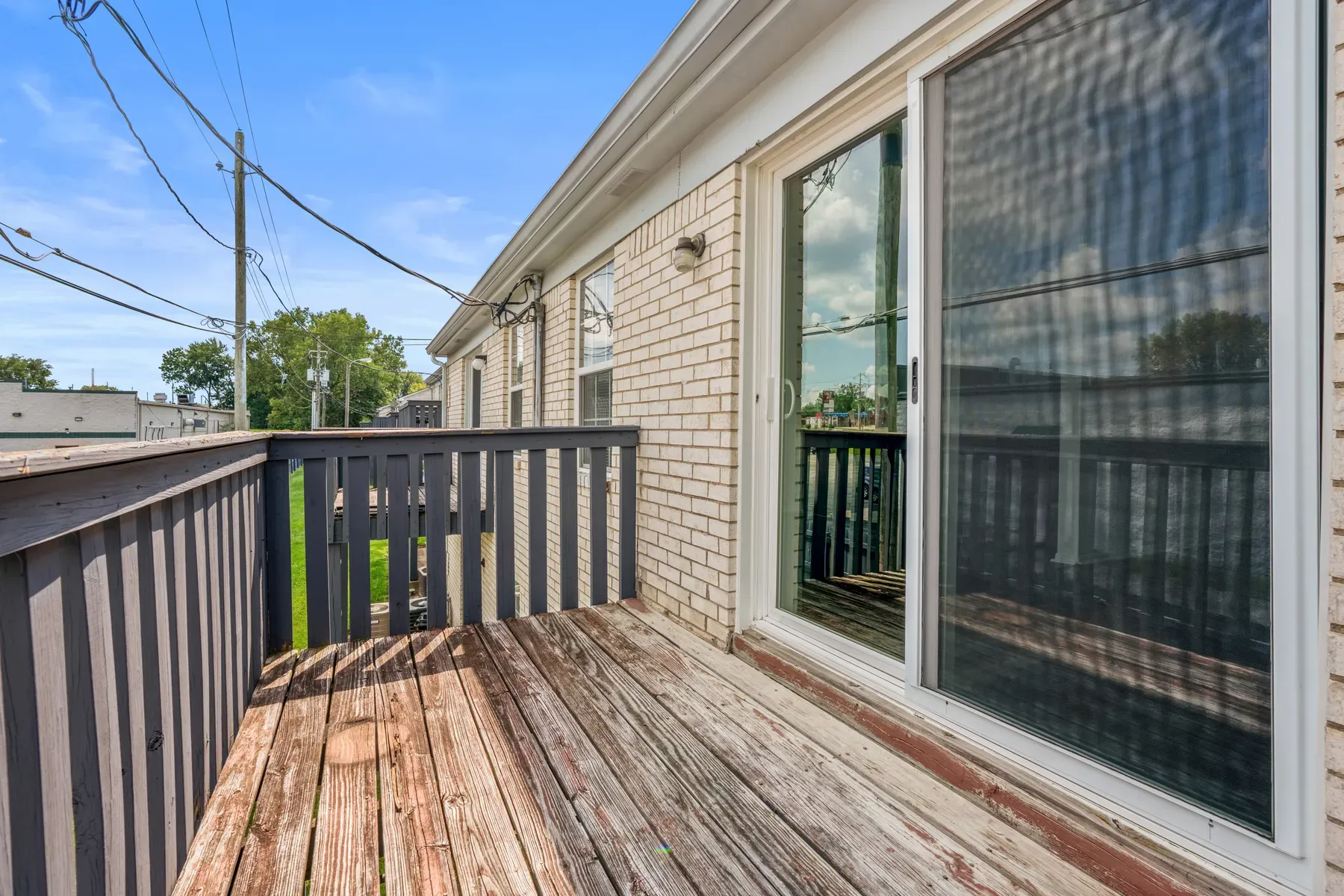 Wood deck and brick exterior of the apartment building
