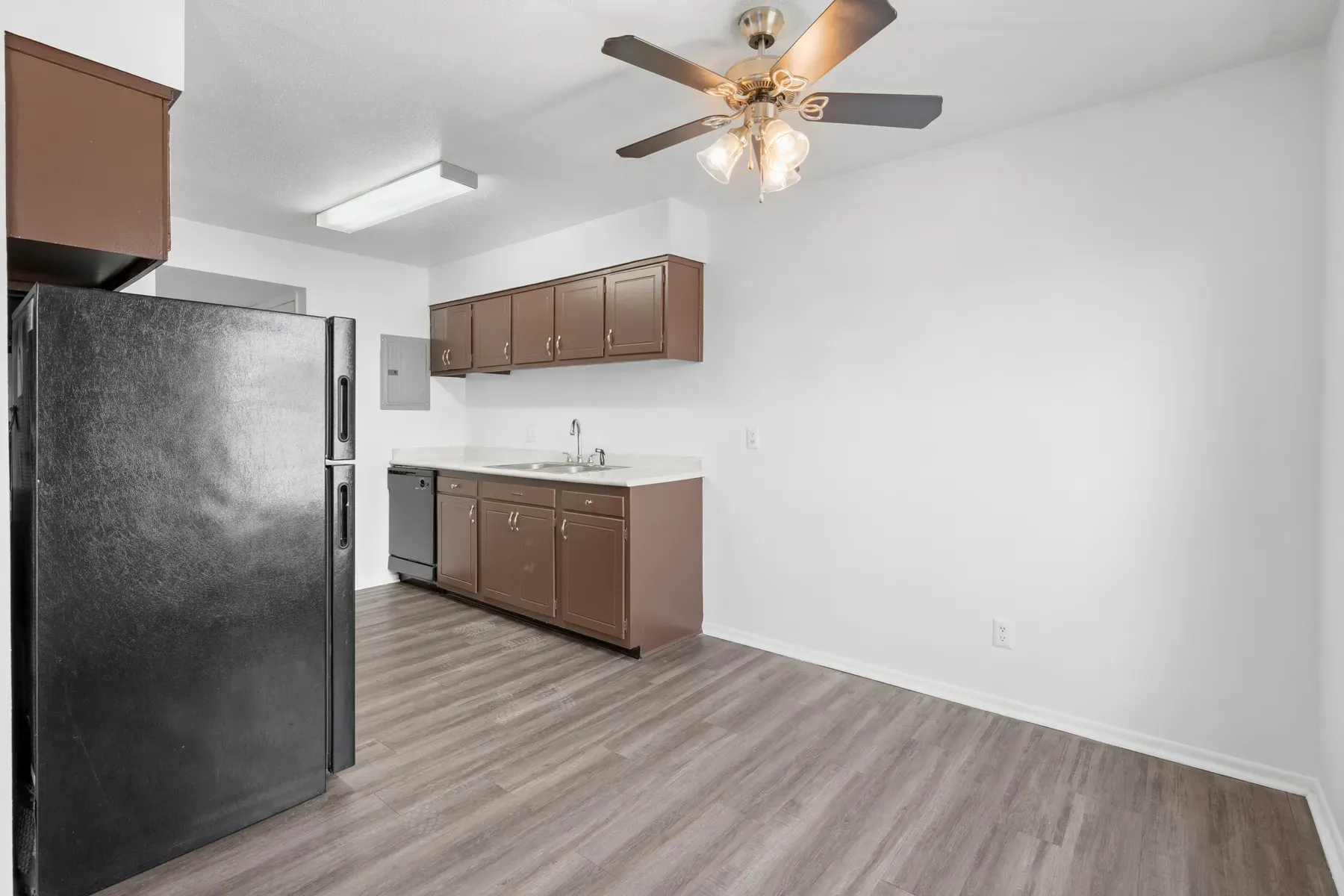 Kitchen with overhead cabinets and a double sink