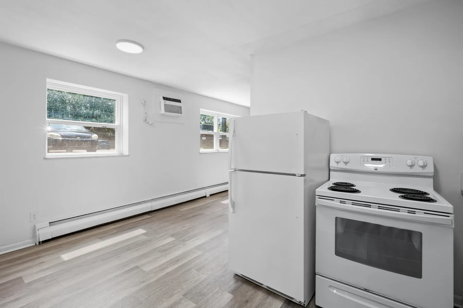 Kitchen open to a living space with a bright window