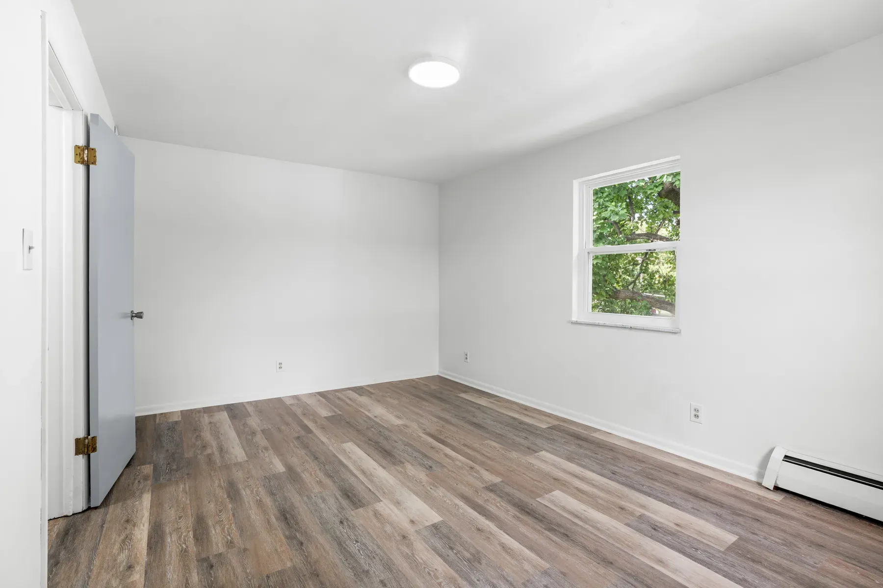 Living room with neutral walls and a sunny window