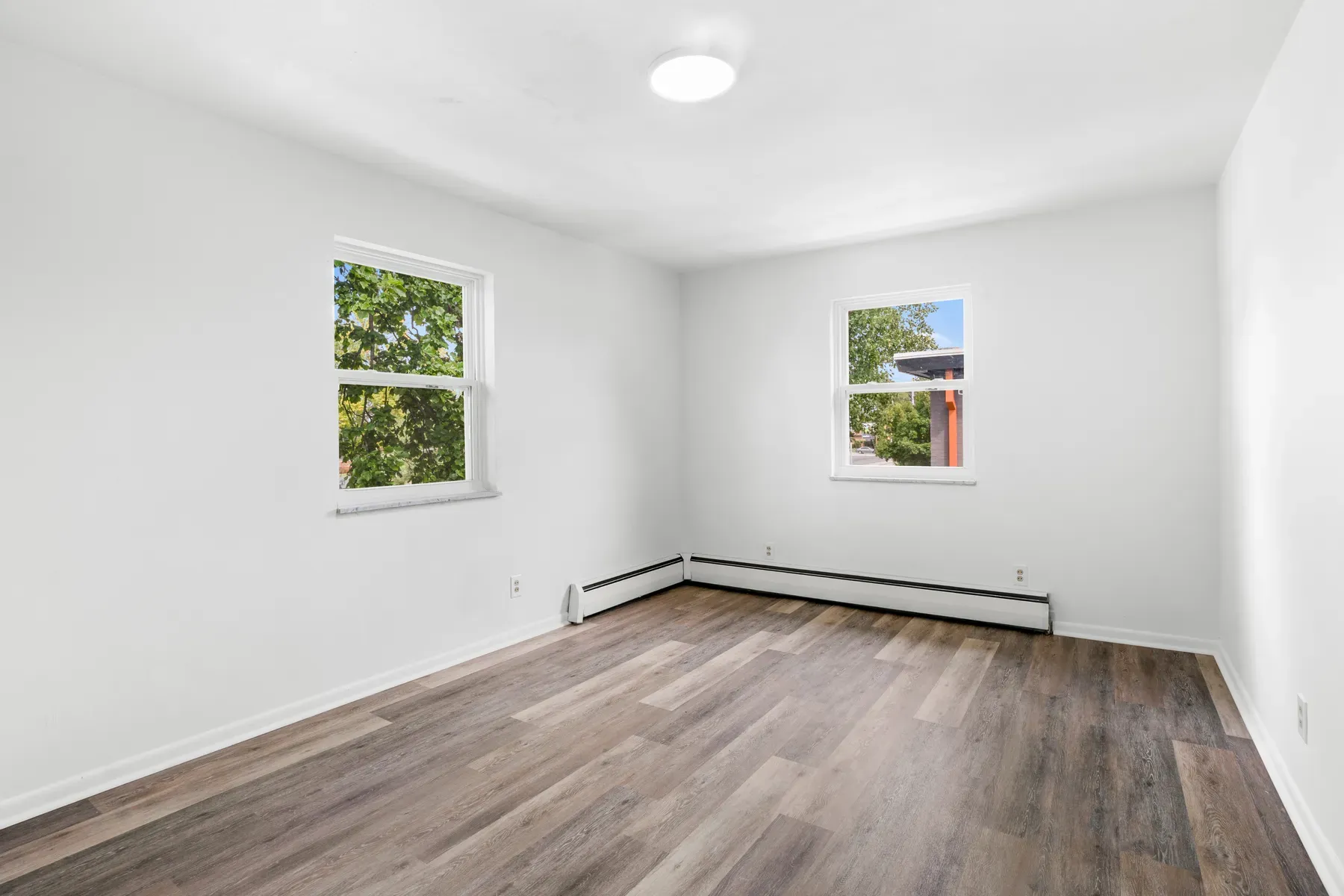 Bedroom with a window and wood-look flooring