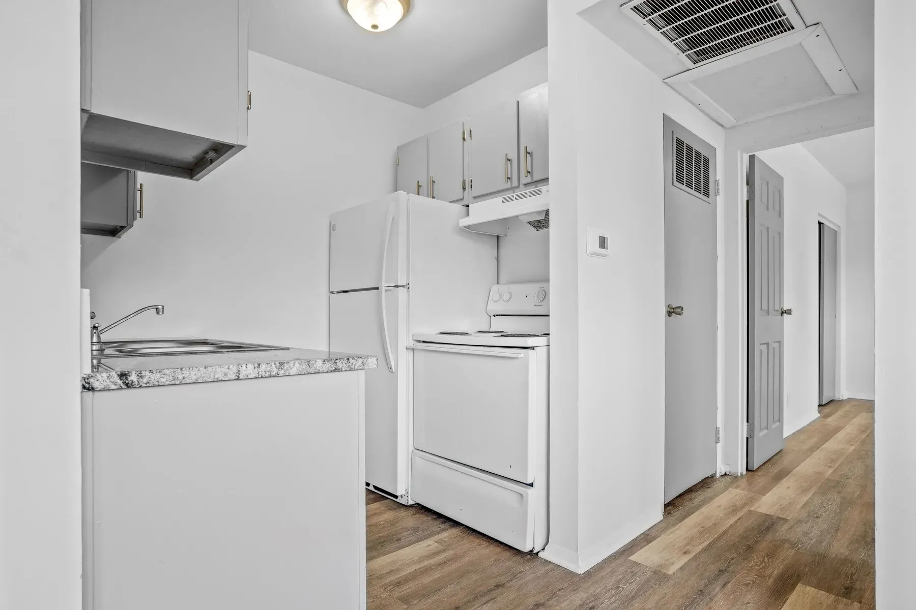 Kitchen with a white refrigerator and electric range