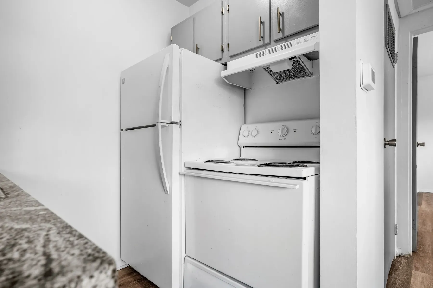 Kitchen with a white refrigerator and overhead cabinets
