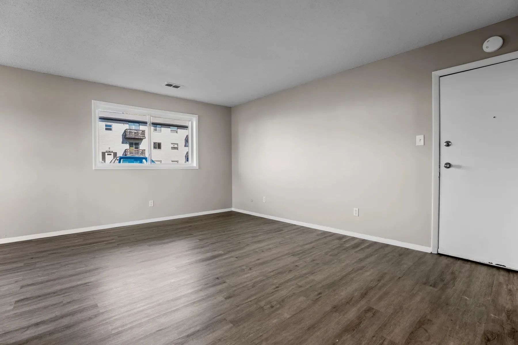 Bright interior room with wide-plank floors